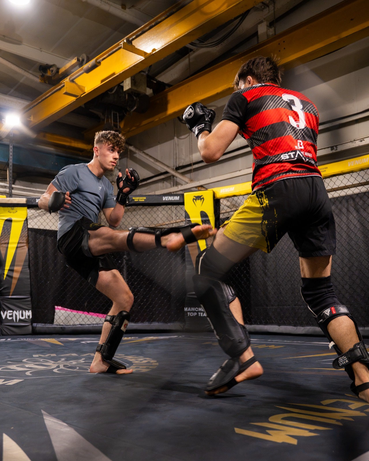 Fighters sparring inside the cage at Manchester Top Team